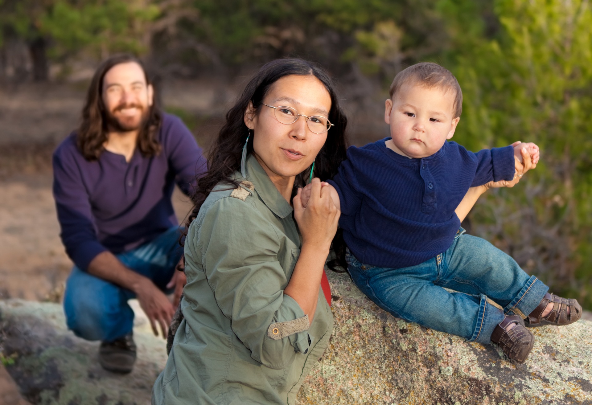 Young Indigenous family in nature.