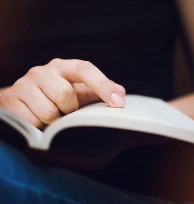 Woman reads a book, close-up.
