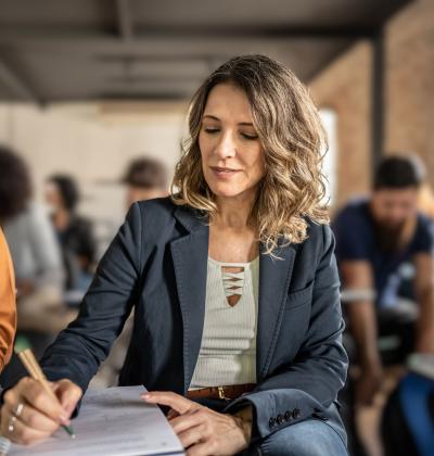 Middle aged woman attending a literacy class.