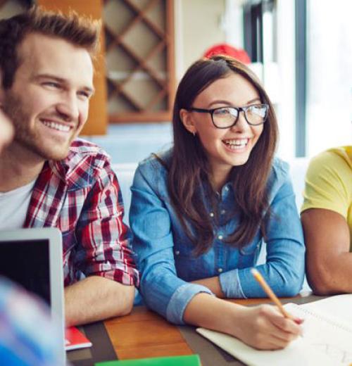 Group of teens gathered to do homework.