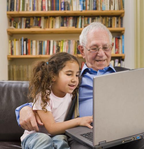 Grandpa and Granddaughter on Computer at Library.