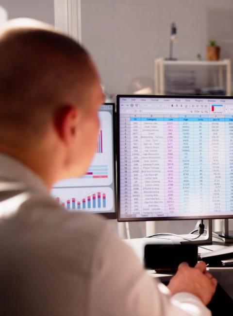 Male Analyst Employee Working on Spreadsheet Using Desktop.
